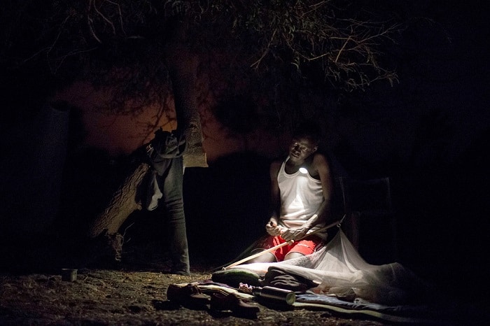 March 2017 – James, a Community Area Supervisor with MSF, organises his bedding for the night close to an MSF outdoor support clinic in Gier, Leer County, South Sudan.