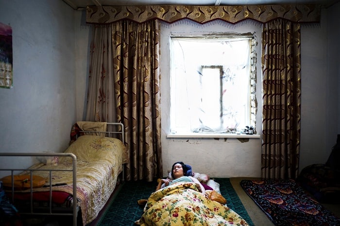 Gulzat, 17, receives a visit from the MSF medical team at home. Gulzat suffered tuberculosis meningitis two years ago and despite medical treatment she did not fully recover. 