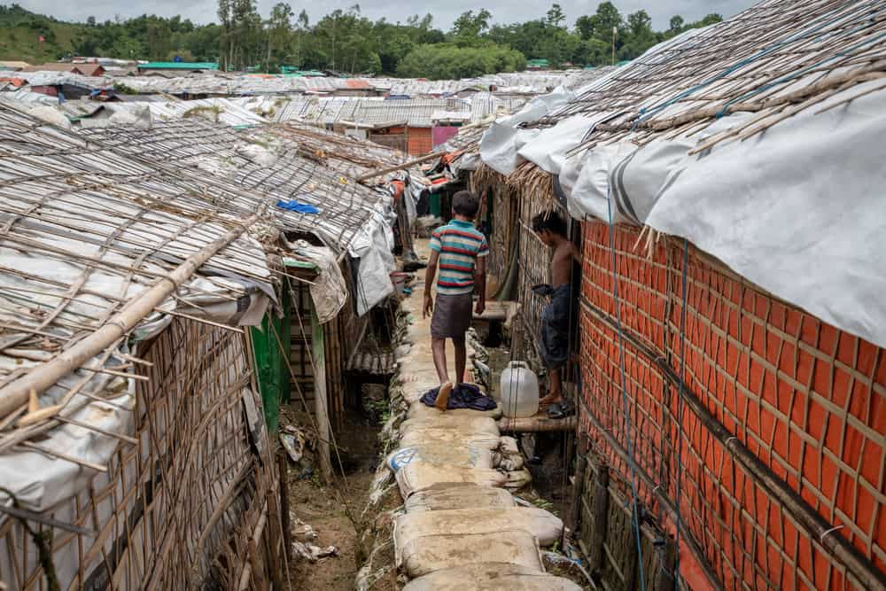A child walks on an elevated foot path reinforced by sandbags in the Unchiprang camp in Cox&rsquo;s Bazar, Bangladesh. Photo: Daphne Tolis/MSF
