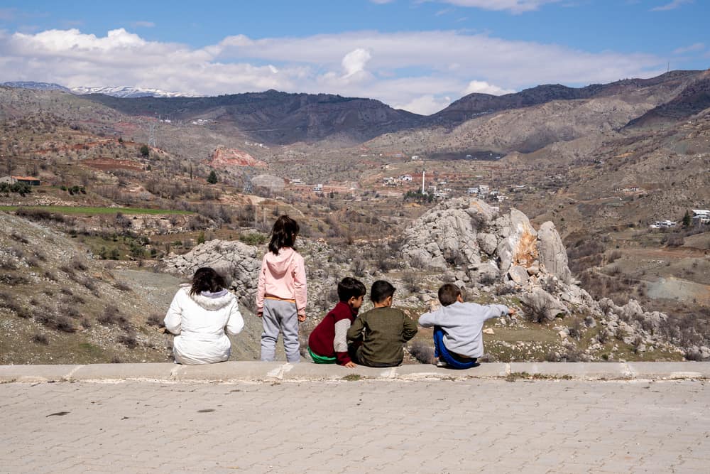 Children gather in Kayatepe (Rezip) village, on the outskirts of Adıyaman.
-
Children are also having to deal with immense trauma. In psychosocial sessions, some of them draw shattered buildings and sad faces, and recall to counsellors the voices of their loved ones calling for help under the rubbles.
Their sense of routine, safety and protection has been shattered. Most of them now lack a physical place they can trust, such as a full-time home and a school. Family members, teachers and friends may no longer be present, as some have been fatally injured or have left to find safety elsewhere. Many children are voicing their fears to their parents but are noticing that the adults they look up to for safety are sad and under acute stress themselves, which adds to family tensions.