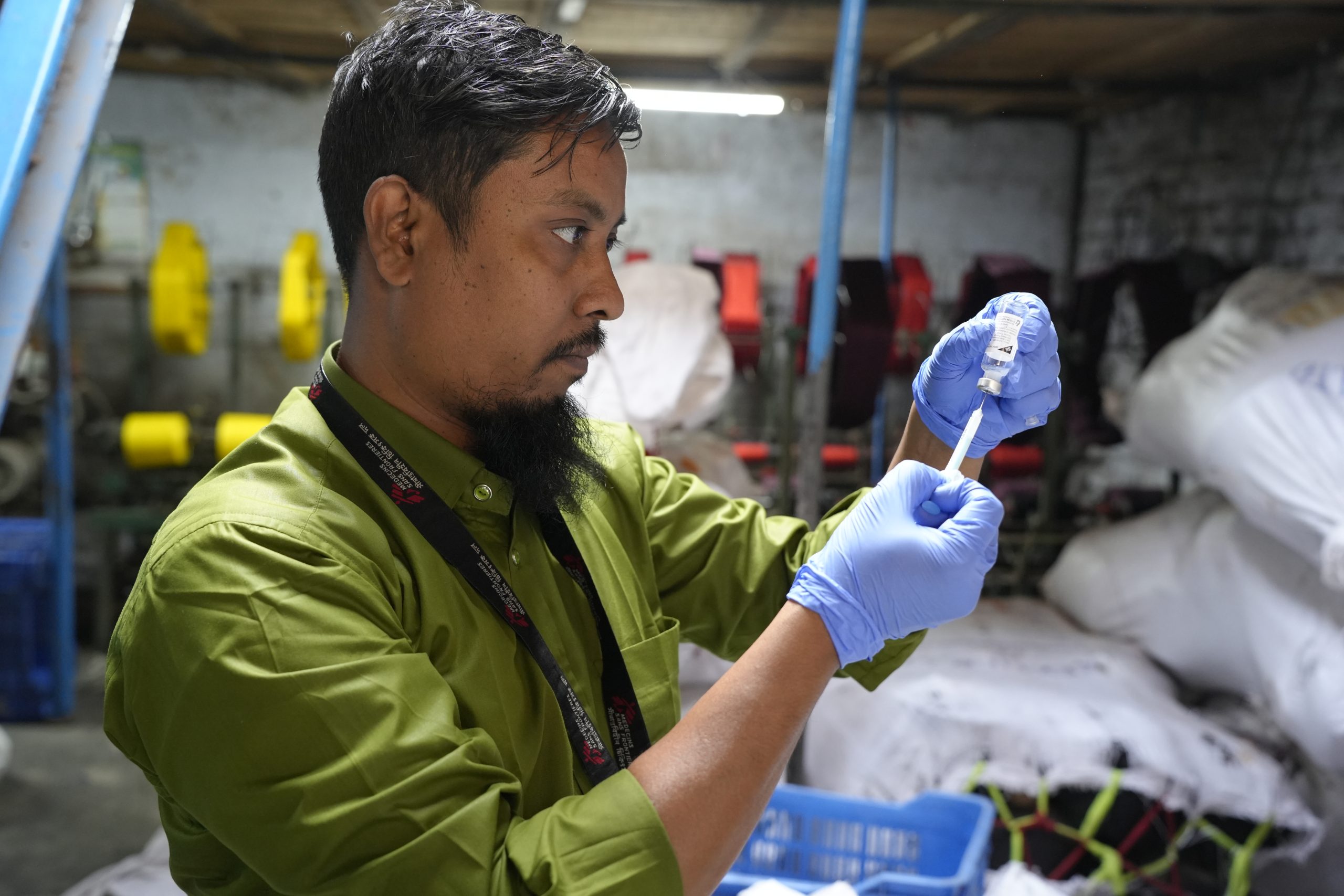 MSF staff member prepares a vaccination for a factory worker in Kamrangirchar. ©️ MSF